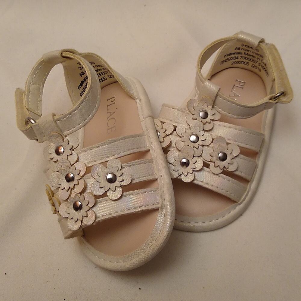 Place Little girls size 3 to 6 month old flower sandals.